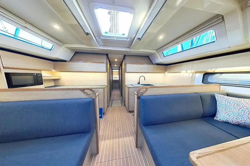 Sea Wave Yacht Photos Pics Luxurious interior of 2024 Kufner 54 yacht with modern kitchen and seating area.