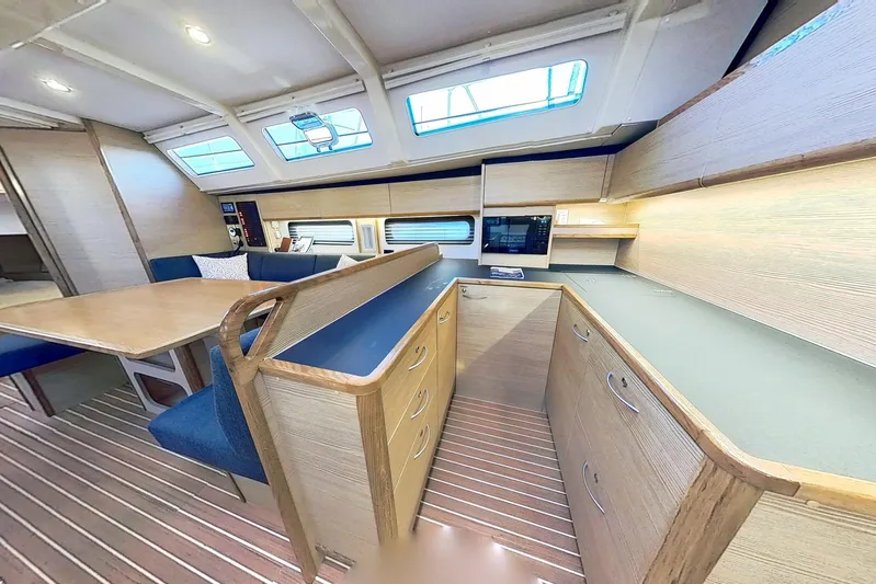 Sea Wave Yacht Photos Pics Luxurious interior of 2024 Kufner 54 yacht with modern kitchen and dining area.