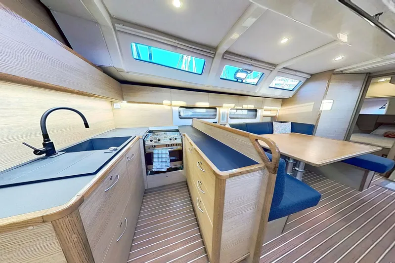 Sea Wave Yacht Photos Pics Luxurious interior of 2024 Kufner 54 yacht with modern kitchen and dining area.