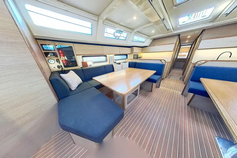 Sea Wave Yacht Photos Pics Luxurious interior of 2024 Kufner 54 yacht with blue seating and wooden accents.