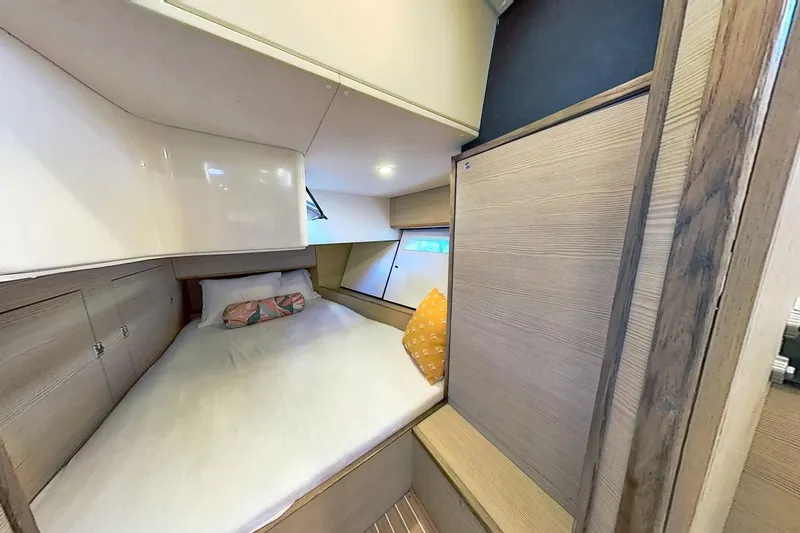 Sea Wave Yacht Photos Pics Cozy cabin interior of 2024 Kufner 54 yacht with comfortable bedding and wooden accents.
