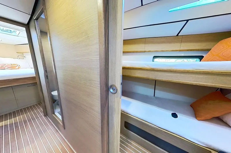 Sea Wave Yacht Photos Pics 2024 Kufner 54 yacht interior with wooden bunk beds and modern design.
