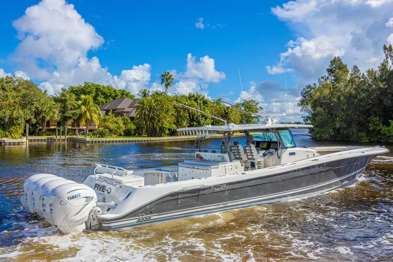 2022 425 Yamahas Yacht Photos Pics 2019 HCB 53 Sue&ntilde;os boat cruising on a scenic waterway with lush greenery.