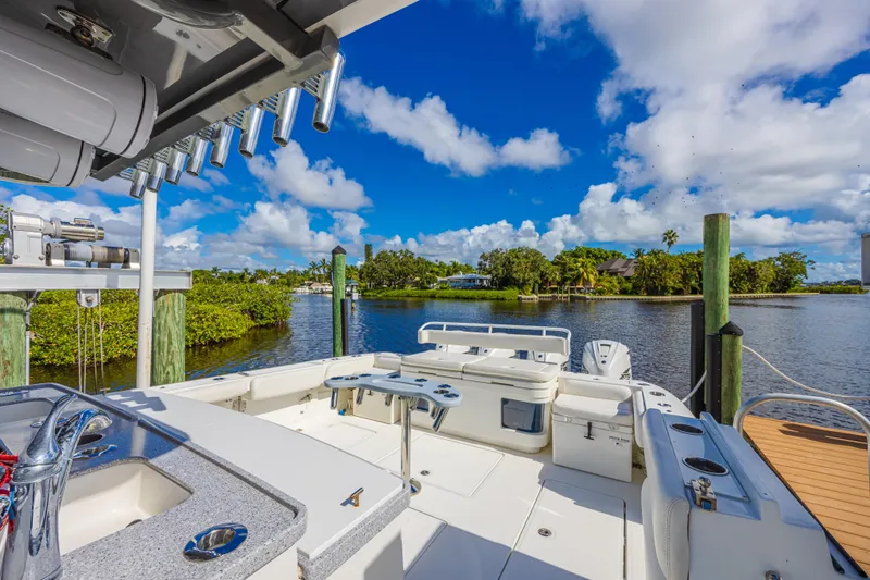 2022 425 Yamahas Yacht Photos Pics 2019 HCB 53 Sue&ntilde;os boat docked by scenic waterfront with lush greenery.