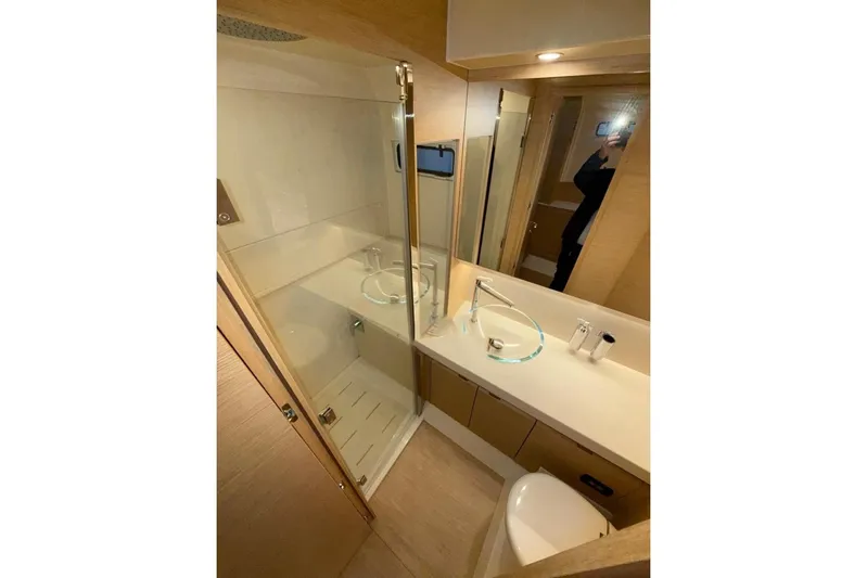  Yacht Photos Pics Luxurious bathroom in 2022 Solaris Power 44 yacht with modern fixtures and glass shower.