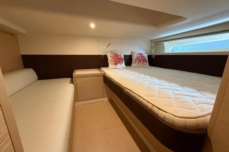  Yacht Photos Pics Luxurious cabin interior of 2022 Solaris Power 44 yacht with cozy bedding.