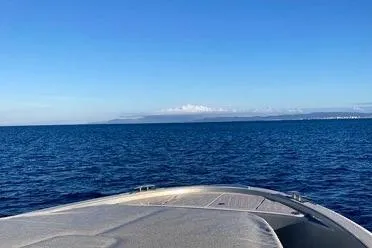  Yacht Photos Pics 2022 Solaris Power 44 yacht cruising on open sea under clear blue sky.