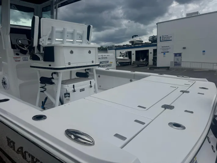  Yacht Photos Pics 2026 Blackfin 262 HB boat with fishing setup, docked under cloudy skies.