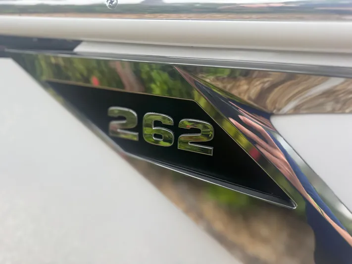  Yacht Photos Pics 2026 Blackfin 262 HB boat emblem with reflective chrome finish.