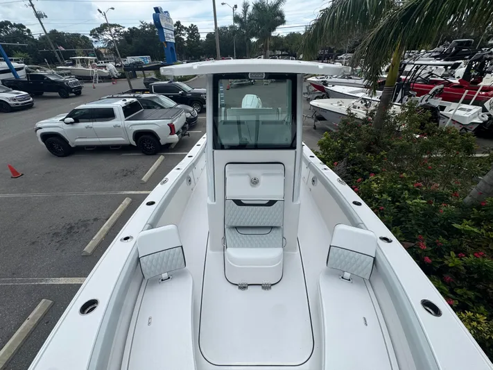  Yacht Photos Pics 2026 Blackfin 262 HB boat in parking lot, surrounded by vehicles and greenery.