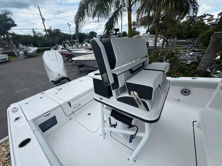  Yacht Photos Pics 2026 Blackfin 262 HB boat with sleek seating, docked near palm trees.