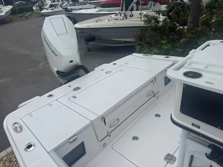  Yacht Photos Pics 2026 Blackfin 262 HB boat with sleek white deck and powerful outboard motor.