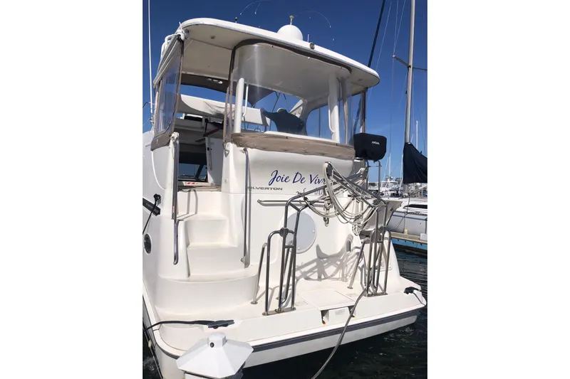 Joie De Vivre Yacht Photos Pics 2003 Silverton 35 Motor Yacht docked, featuring a spacious rear deck and elegant design.