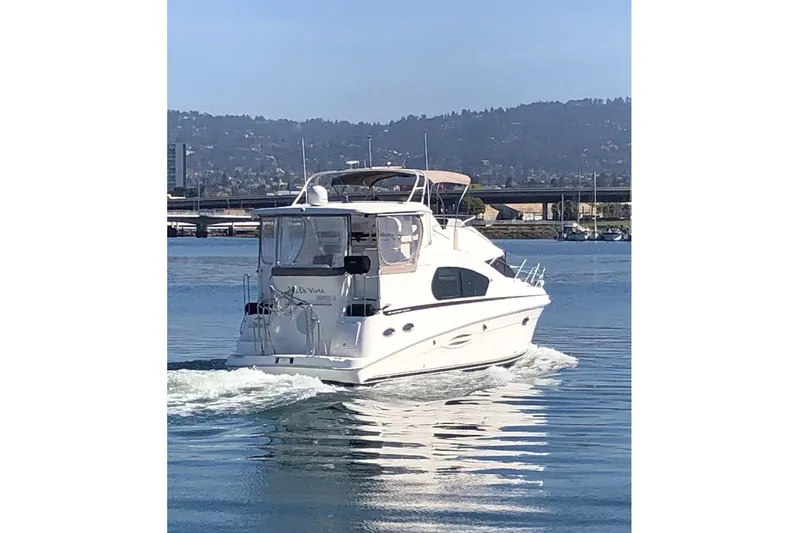 Joie De Vivre Yacht Photos Pics 2003 Silverton 35 Motor Yacht cruising on a calm lake with scenic mountain backdrop.