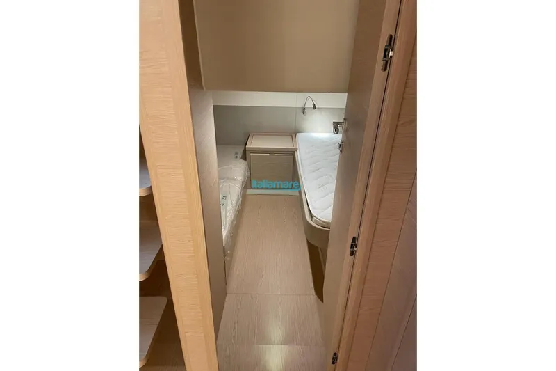  Yacht Photos Pics 2024 Solaris Power 44 Open cabin interior with wooden finish and cozy bed.