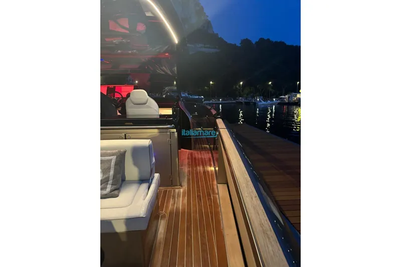  Yacht Photos Pics 2024 Solaris Power 44 Open yacht docked at night, featuring elegant deck and seating.