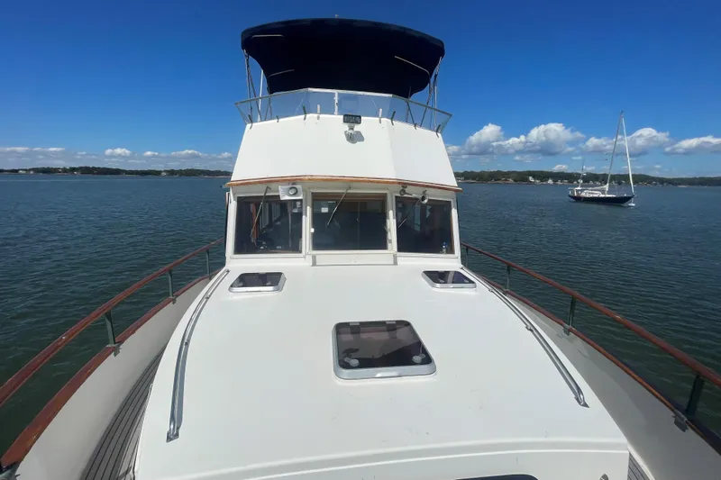 Island Girl Yacht Photos Pics 1990 Grand Banks 46 Classic yacht on calm waters under a clear blue sky.