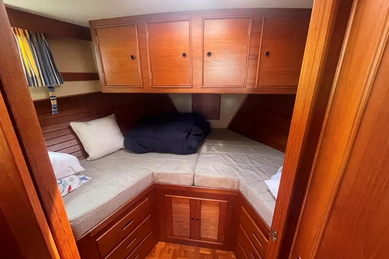 Island Girl Yacht Photos Pics Cozy cabin interior of 1990 Grand Banks 46 Classic yacht with wooden cabinetry and twin beds.