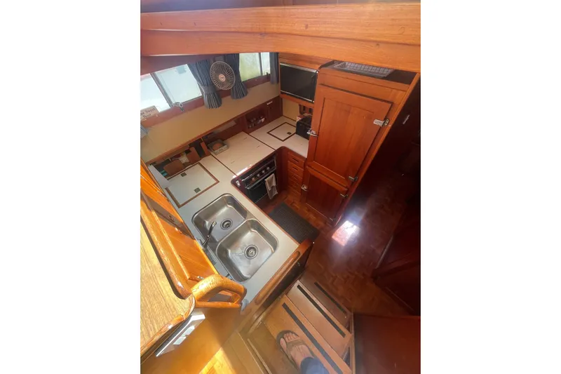Island Girl Yacht Photos Pics Interior of 1990 Grand Banks 46 Classic yacht, featuring a compact kitchen with dual sinks.