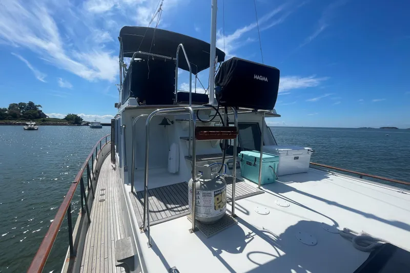 Island Girl Yacht Photos Pics 1990 Grand Banks 46 Classic yacht on calm water under a clear blue sky.