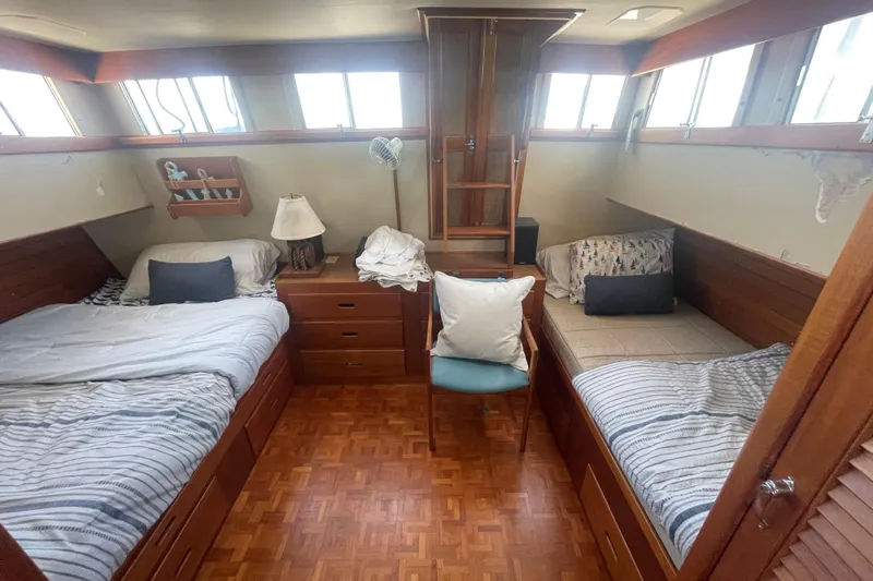 Island Girl Yacht Photos Pics Cozy cabin interior of 1990 Grand Banks 46 Classic yacht with twin beds and wooden furnishings.