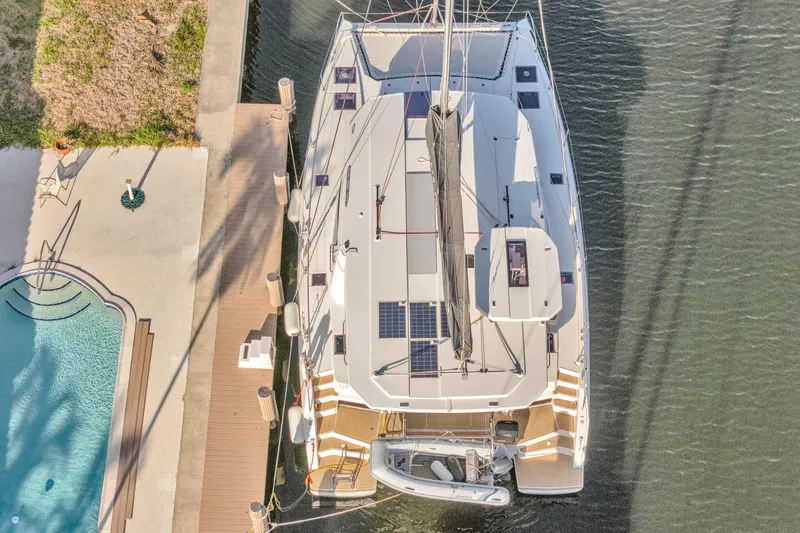  Yacht Photos Pics Aerial view of 2020 Leopard 45 catamaran docked beside a pool.