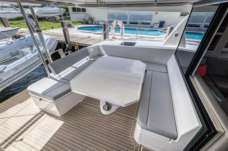  Yacht Photos Pics Leopard 45 catamaran 2020 model with spacious outdoor seating and table on deck.