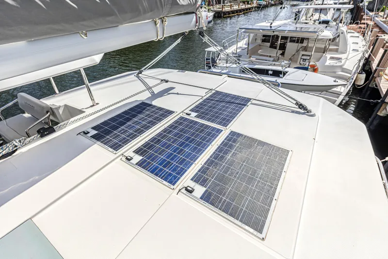  Yacht Photos Pics 2020 Leopard 45 catamaran with solar panels on deck, docked at marina.