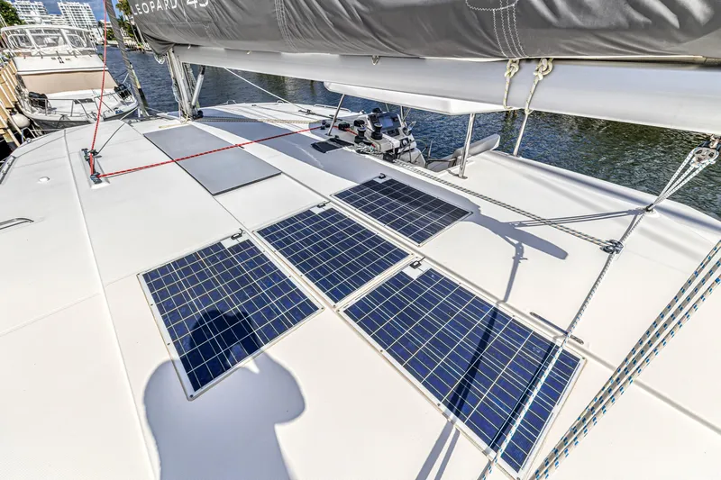  Yacht Photos Pics 2020 Leopard 45 catamaran with solar panels on deck, docked at marina.