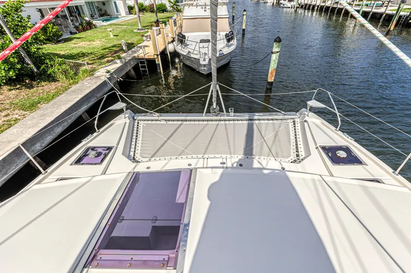  Yacht Photos Pics Front deck view of a 2020 Leopard 45 catamaran docked by a canal.