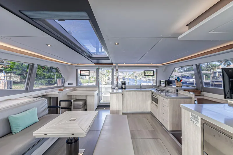  Yacht Photos Pics Luxurious interior of a 2020 Leopard 45 catamaran with modern kitchen and seating area.