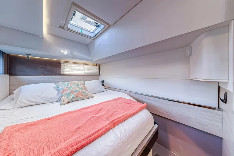  Yacht Photos Pics Luxurious cabin interior of 2020 Leopard 45 yacht with skylight and cozy bedding.