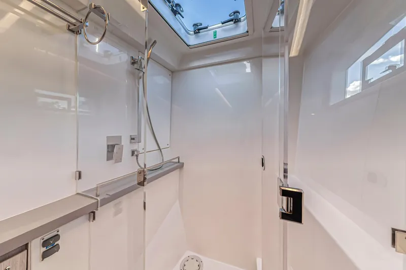  Yacht Photos Pics Modern shower area in 2020 Leopard 45 yacht with skylight and sleek fixtures.