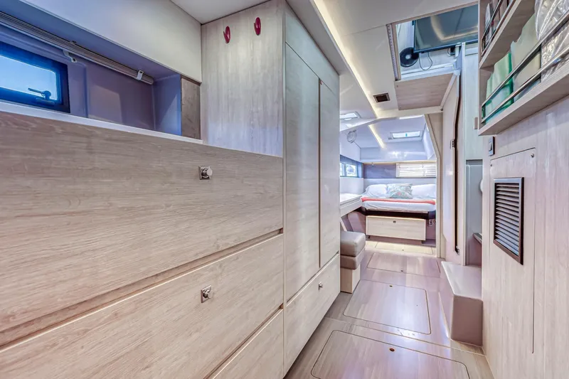  Yacht Photos Pics Luxurious interior of a 2020 Leopard 45 catamaran, featuring modern wood finishes and cozy sleeping area.