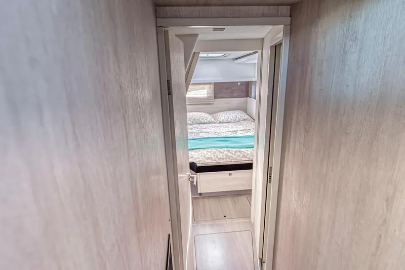  Yacht Photos Pics Narrow hallway leading to a cozy bedroom in a 2020 Leopard 45 yacht.