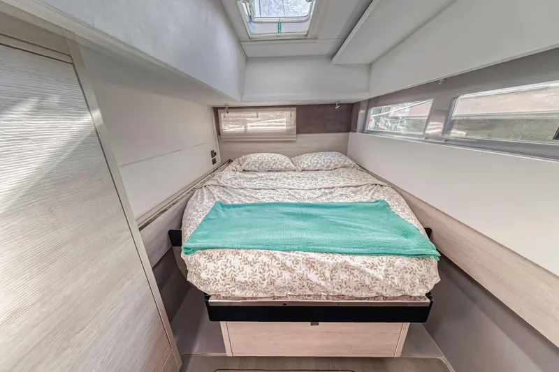  Yacht Photos Pics Cozy bedroom interior of 2020 Leopard 45 yacht with skylight and modern design.