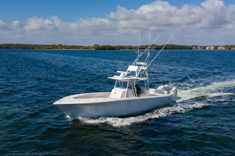  Yacht Photos Pics 2025 SeaVee 370Z boat cruising on open water under a partly cloudy sky.