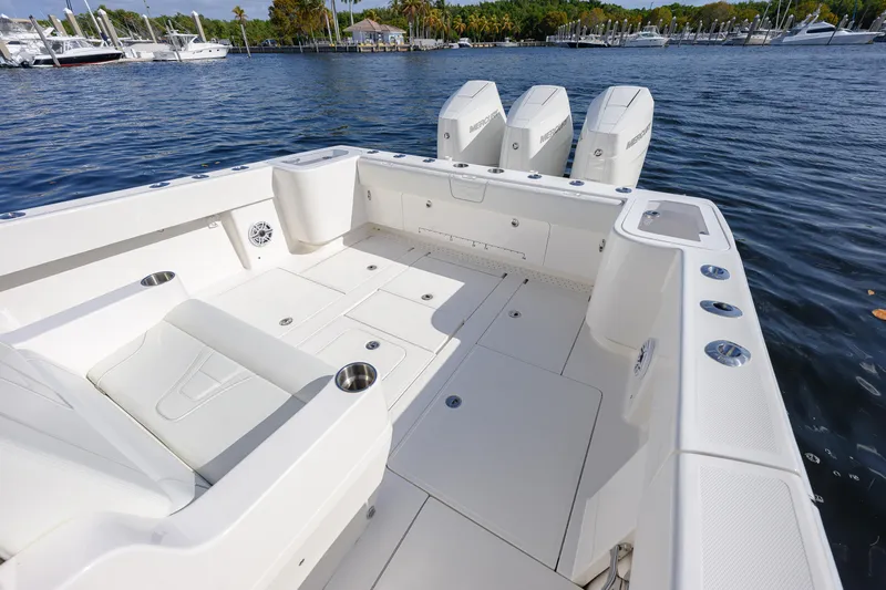  Yacht Photos Pics 2025 SeaVee 370Z boat deck with triple Mercury engines, docked in a marina.