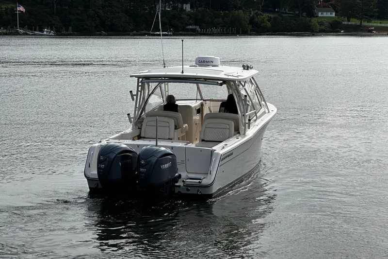  Yacht Photos Pics 2023 Grady-White Freedom 307 boat with dual Yamaha engines on a calm lake.