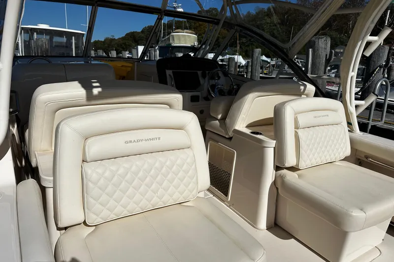  Yacht Photos Pics 2023 Grady-White Freedom 307 boat interior with luxurious white seating.