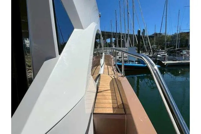  Yacht Photos Pics Sessa Marine F47 yacht, 2025 model, docked with sleek design and wooden deck.