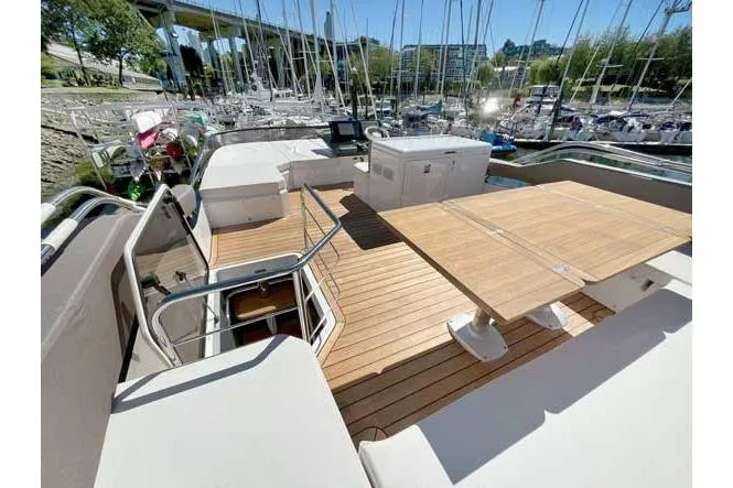  Yacht Photos Pics 2025 Sessa Marine F47 yacht deck with wooden flooring and seating area.