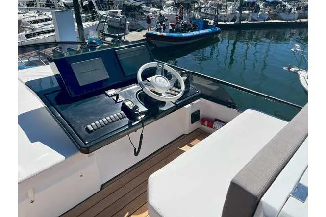  Yacht Photos Pics Helm of 2025 Sessa Marine F47 yacht with modern controls and waterfront view.