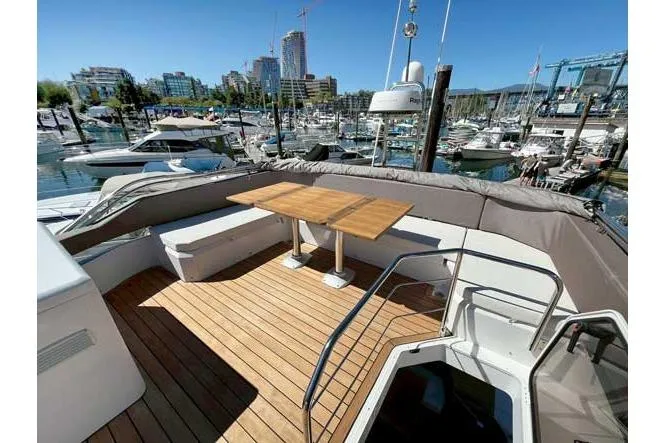  Yacht Photos Pics Luxury Sessa Marine F47 yacht deck with wooden table, marina view, 2025 model.