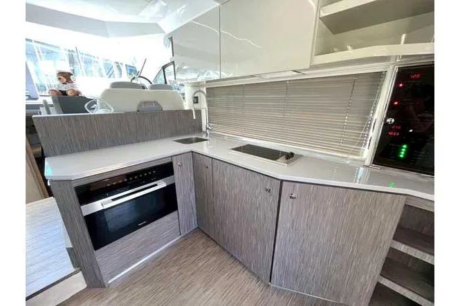  Yacht Photos Pics Modern kitchen interior of 2025 Sessa Marine F47 yacht with sleek cabinetry and appliances.