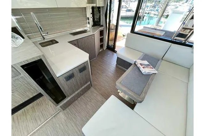 Yacht Photos Pics Modern interior of 2025 Sessa Marine F47 yacht with sleek kitchen and seating area.