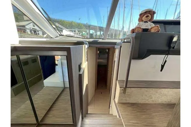  Yacht Photos Pics Interior of 2025 Sessa Marine F47 yacht with plush bear on dashboard.