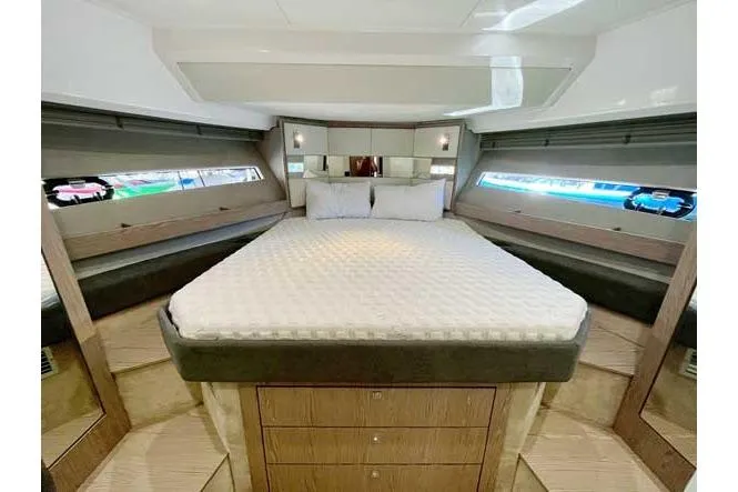  Yacht Photos Pics Luxurious cabin interior of 2025 Sessa Marine F47 yacht with elegant bedding and modern design.