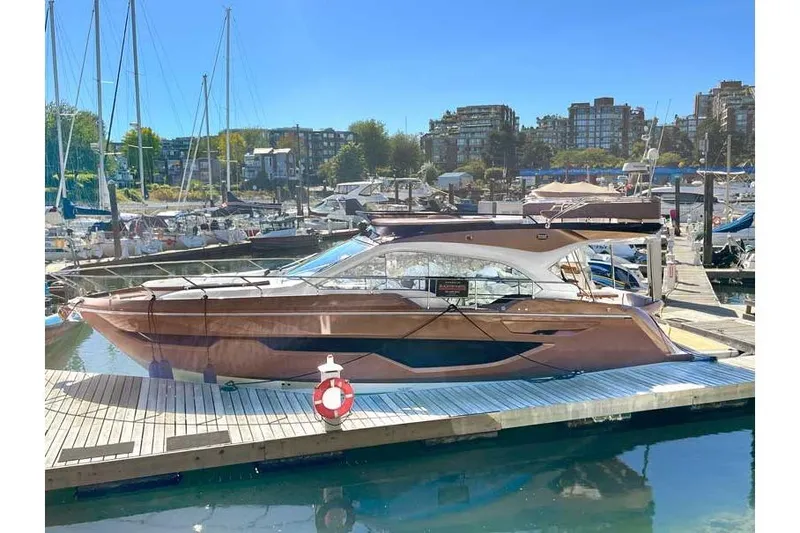  Yacht Photos Pics 2025 Sessa Marine F47 yacht docked at a marina under clear blue skies.