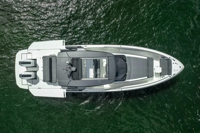  Yacht Photos Pics Aerial view of 2025 Limitless Seas XLV 45 luxury yacht on green water.